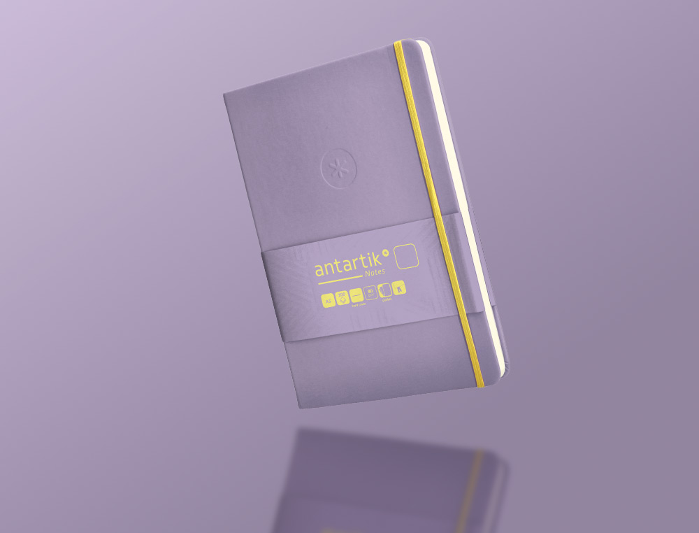 CUADERNO CON GOMILLA ANTARTIK NOTES TAPA DURA A5 HOJAS LISAS MORADO Y AMARILLO 100 HOJAS 80 GR FSC